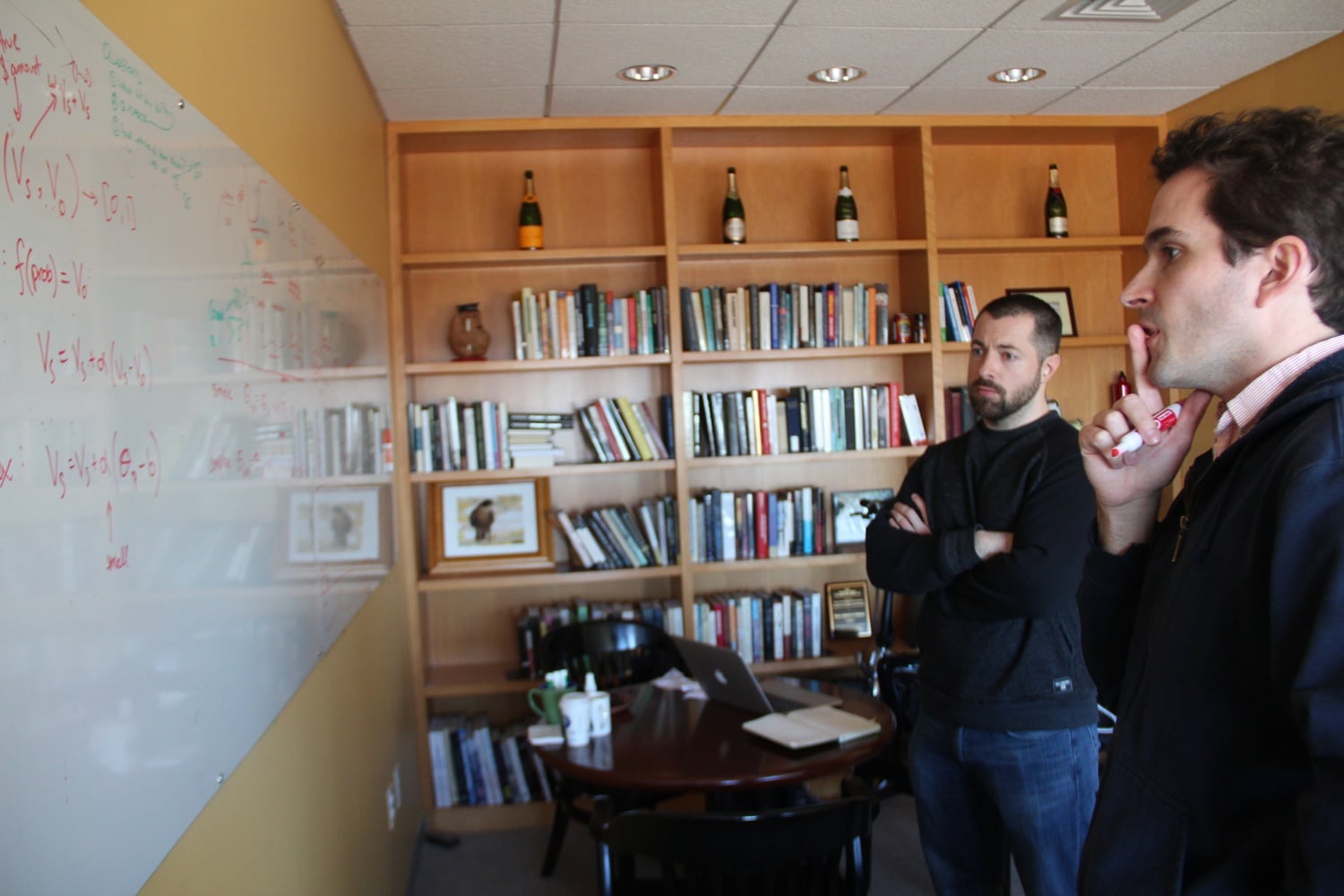 Professor Cushman discusses current lab projects with a colleague.