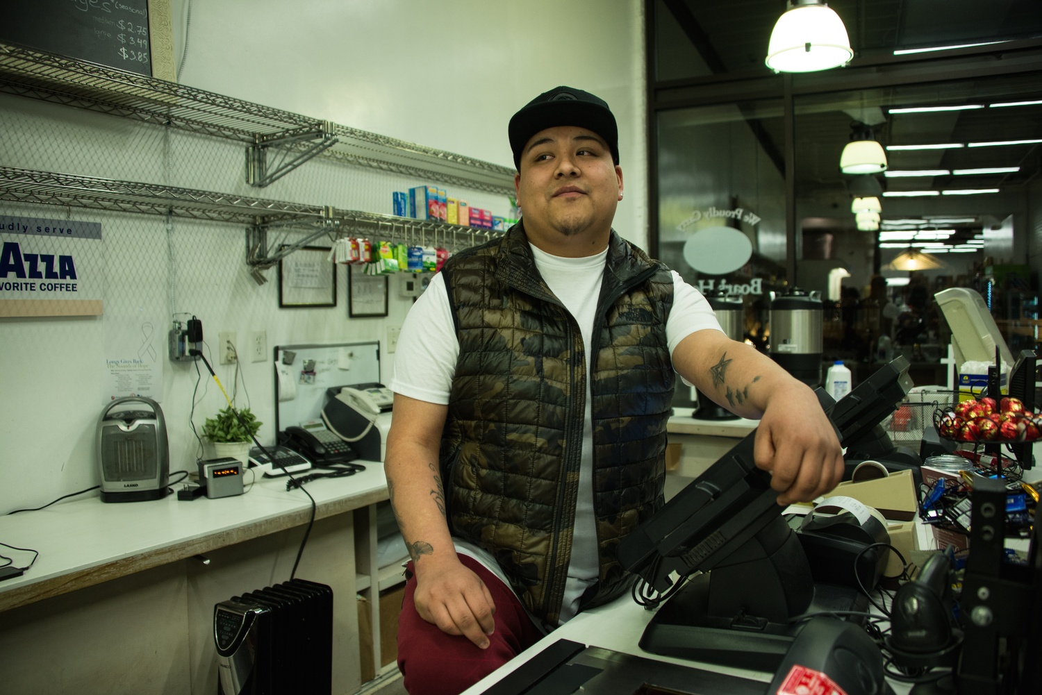 Rigo poses at the cashier desk.