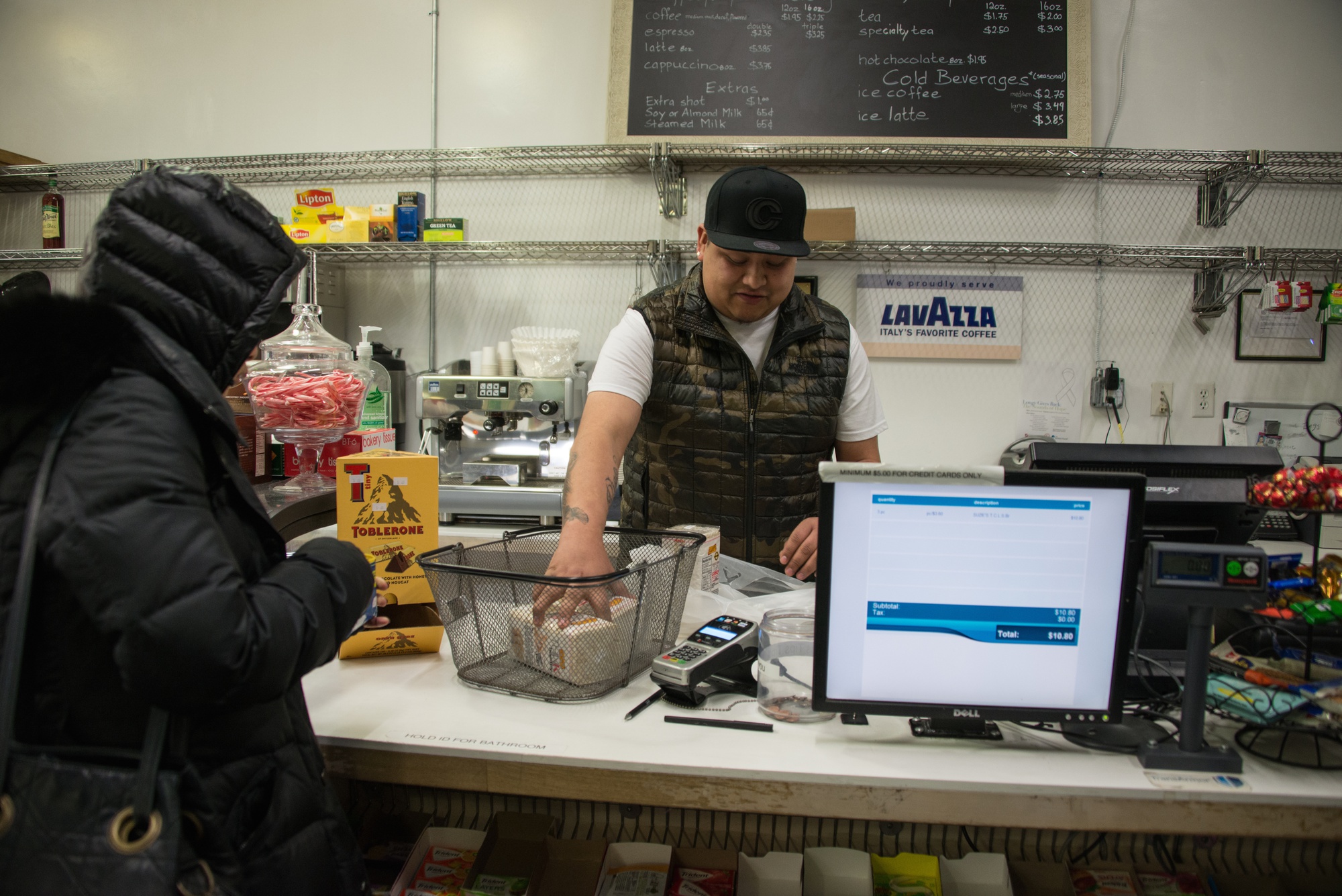 Rigo Perez helps a customer at Market