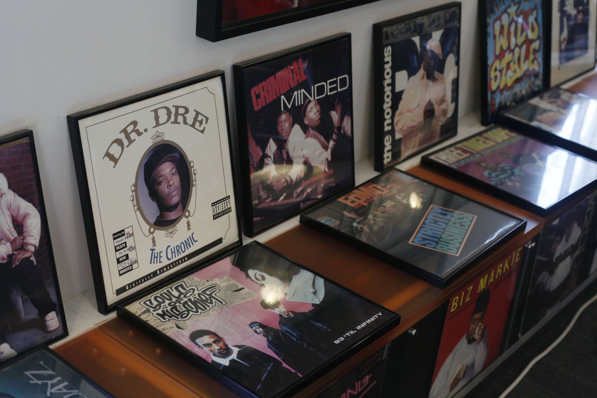 Framed album covers line the walls at the Hiphop Archive and Research Institute. 