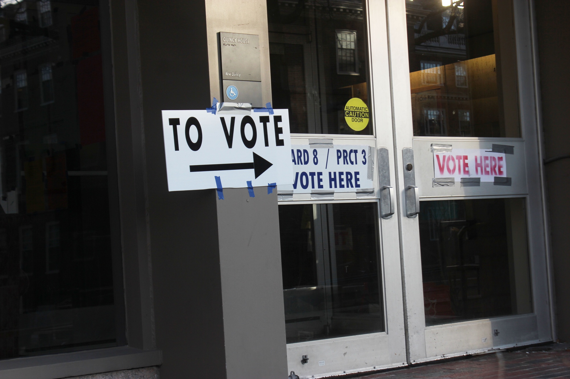 Signs direct voters to the polls located inside Quincy House. Massachusetts and 12 other states held their presidential primary elections on Tuesday. 