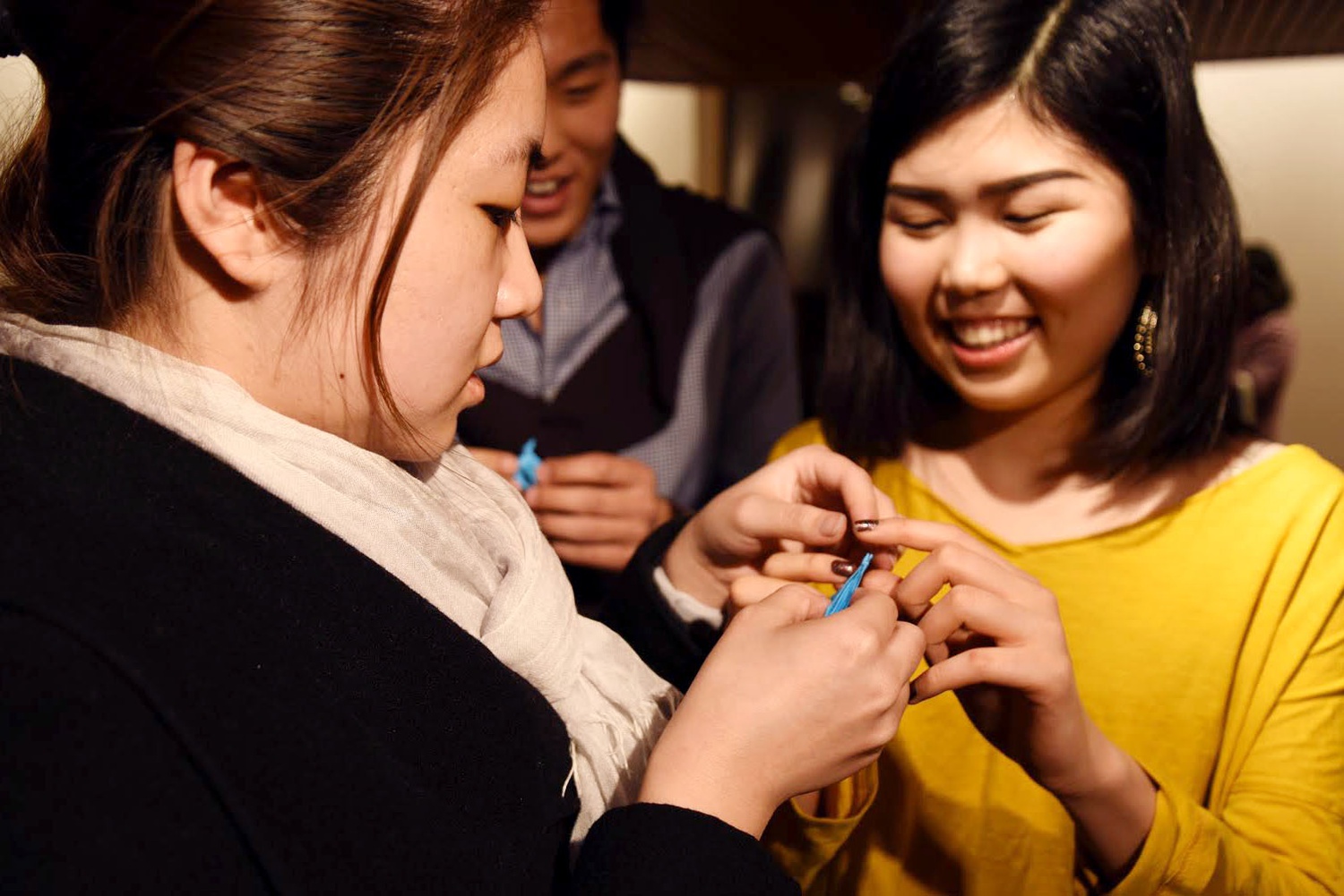 Hana Seita ’19, co-president of the Harvard Japanese Society, helps Hannah Shen ’19 fold a paper crane on Tuesday evening. The study break was in memory of the Tohoku earthquake and tsunami that hit Japan on March 11, 2011.