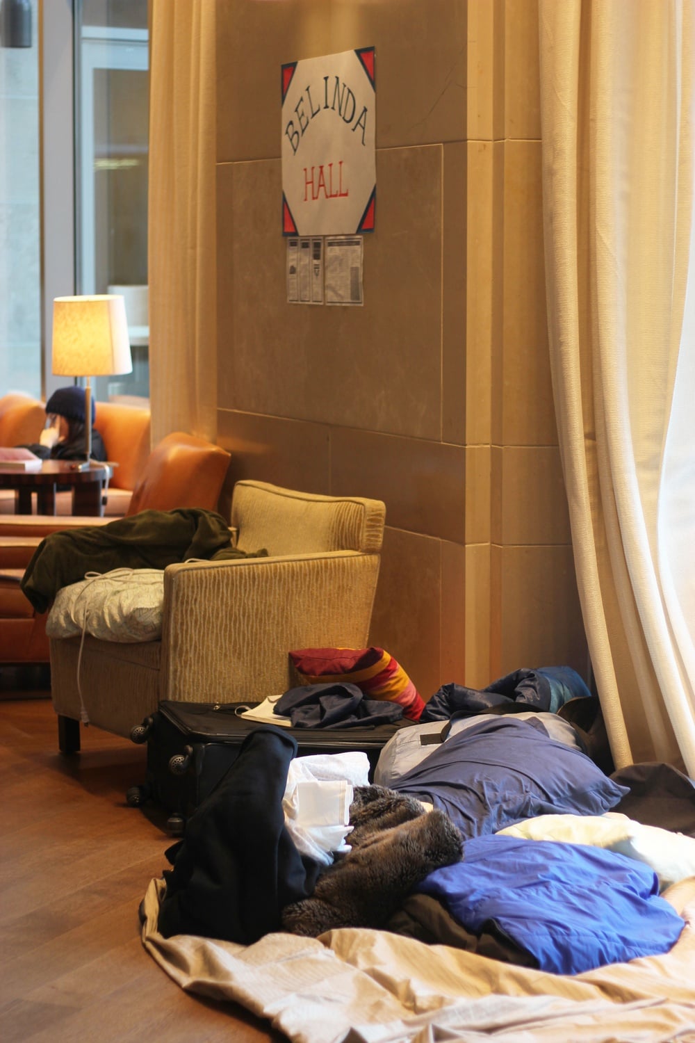 Pillows, blankets, and suitcases cover the floor in the Law School’s Caspersen Student Center lounge so student activists can continue to occupy the space as part of the Reclaim Harvard Law protests. The activists have now occupied the lounge, which they have dubbed “Belinda Hall,” for three weeks and plan to continue the occupation for the foreseeable future.