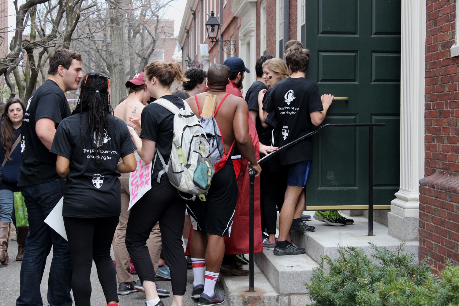 Members of Kirkland House enter Wigglesworth Hall to announce housing decisions to expectant freshmen. 