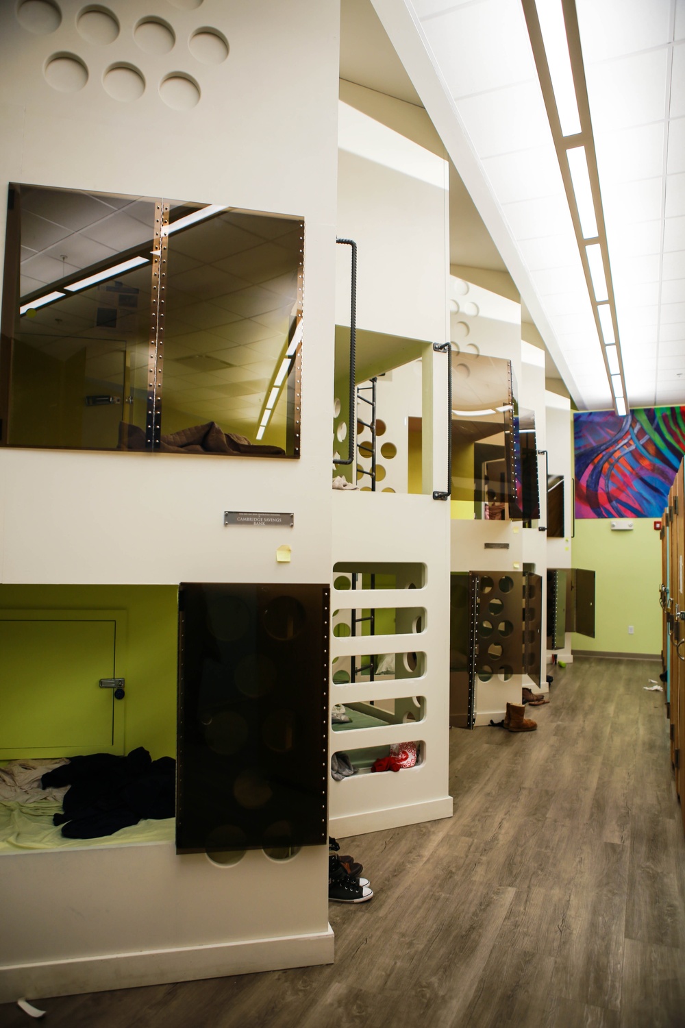 Bunk beds, also known as "pods," line the back wall of Y2Y. The bunk beds are designed with the purpose of giving guests a sense of privacy while also being readily accessible to volunteers. 