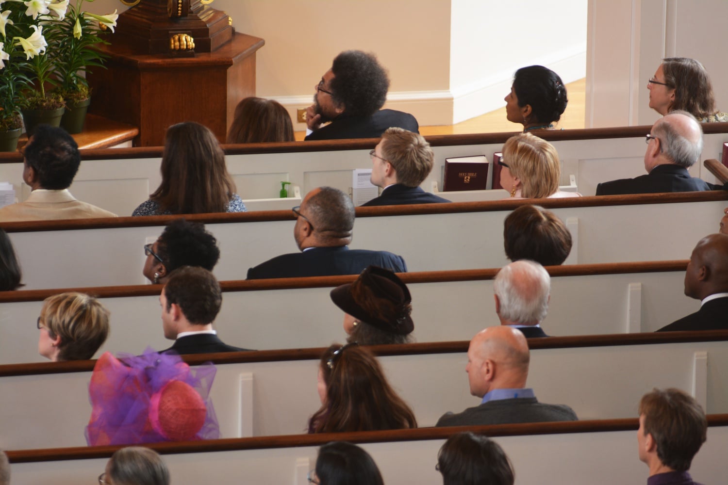 Attendees of the Easter Service in Memorial Church Sunday morning are seen watching on as Professor Jonathan Walton delivers the sermon. Worshippers present included Dr. Cornel West, Professor of Philosophy and Christian Practice at Union Theological Seminary and Professor Emeritus at Princeton University, who is seen seated in the first pew, and Dr. S. Allen Counter, Director of the Harvard Foundation for Intercultural and Race Relations and Professor of Neurology at Harvard Medical School, who is in the second. 
