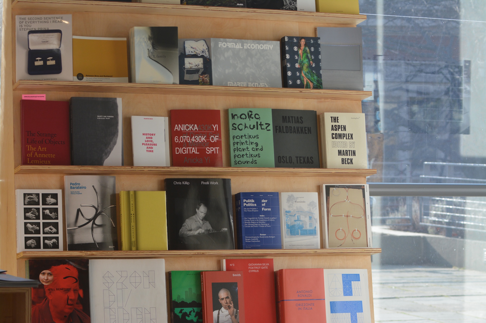 Books line up near the window of the Consumer Research Center/bookshop, an exhibit at the Carpenter Center for the Visual Arts