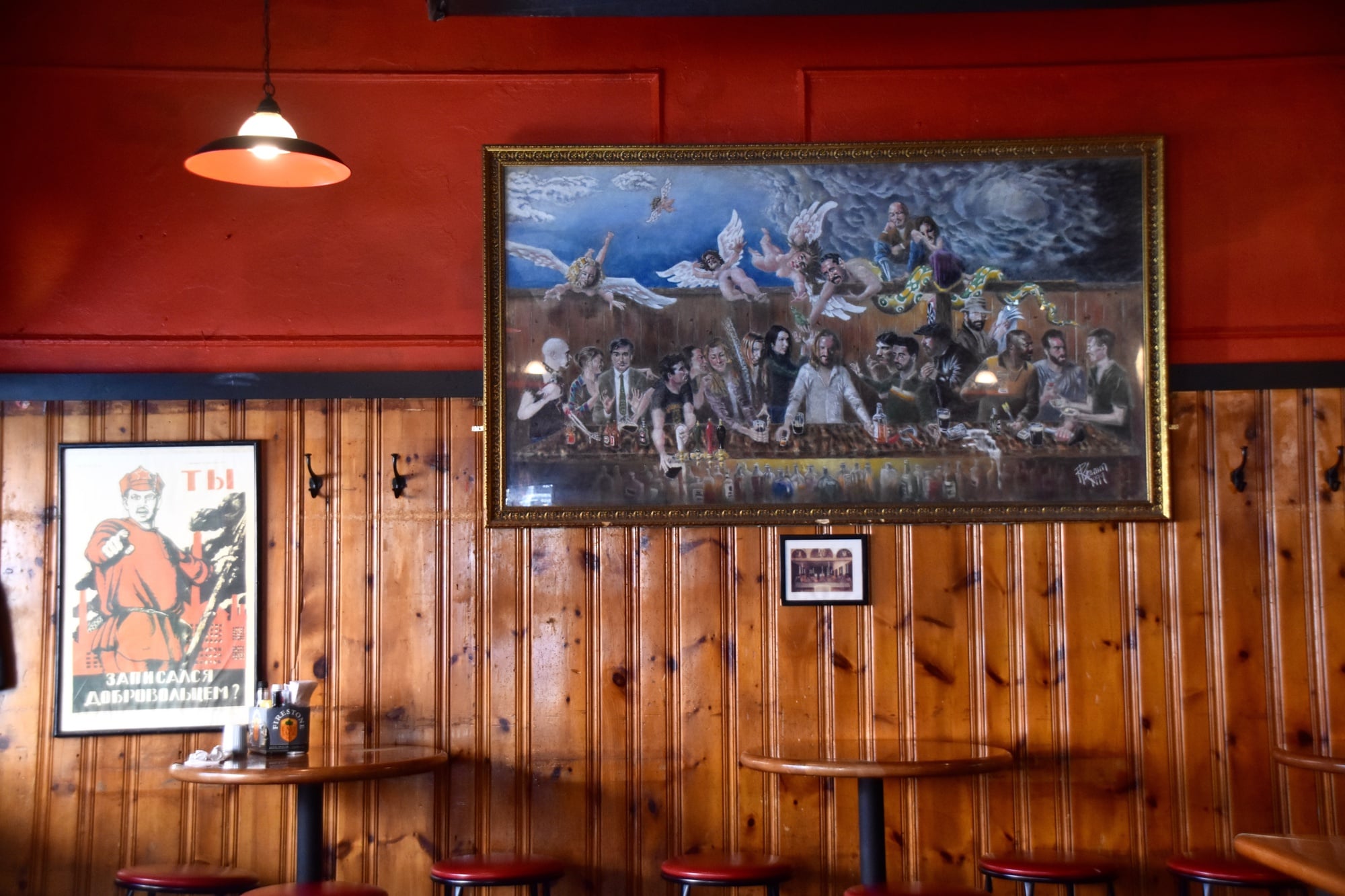 A painting in the style of “The Last Supper,” featuring historic patrons, hangs on a wall at the People’s Republik.
