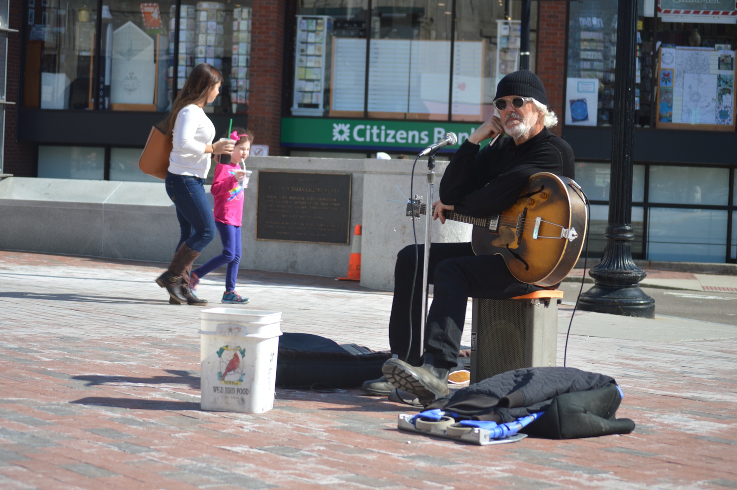 A guitarist busks near Brattle Square on Wednesday afternoon. 