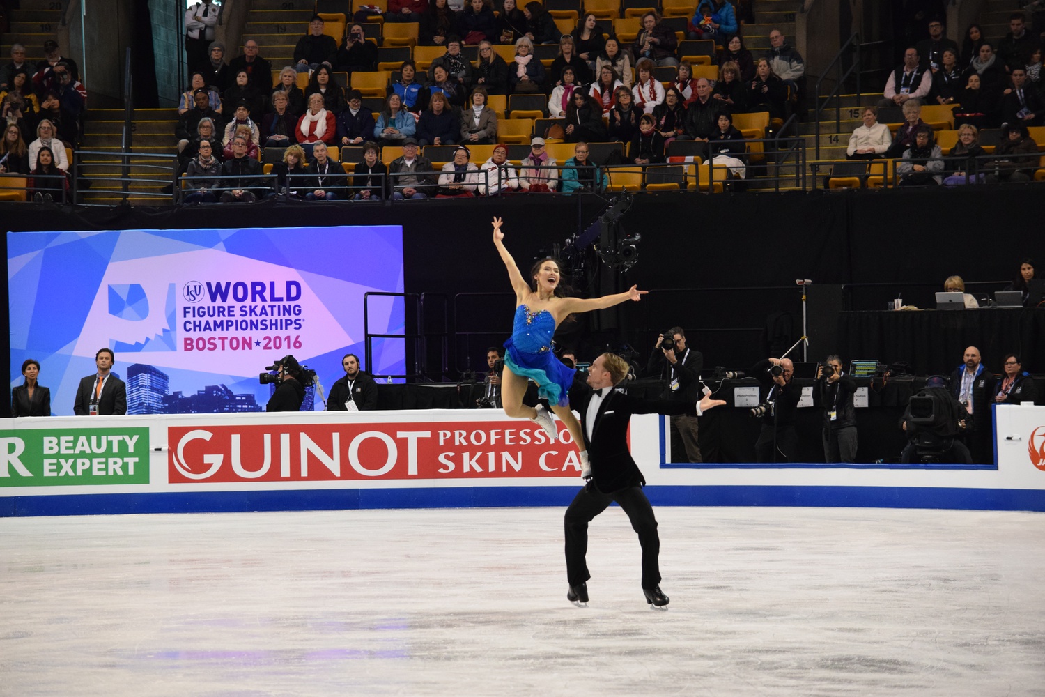 Evan Bates lifts Madison Chock during the short dance competition of the 2016 World Figure Skating Championship held in Boston.