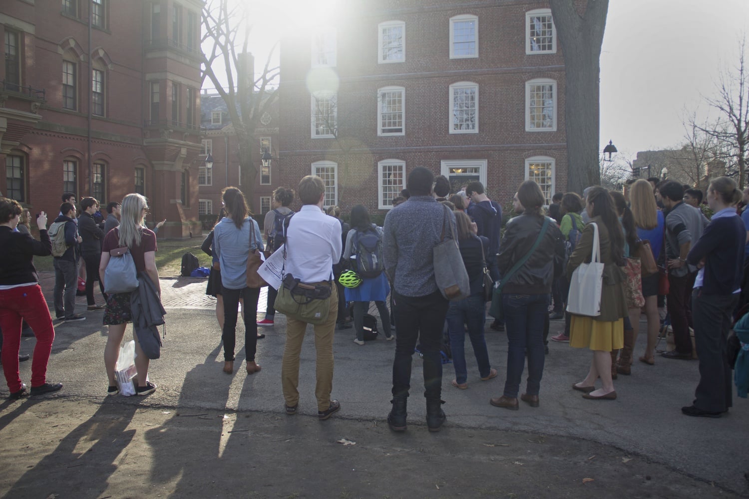 Students from the Graduate School of Arts and Sciences, along with supporters, gather for a protest outside Massachusetts Hall Friday evening. The protest was in demand that more steps be taken to increase diversity at the school.
