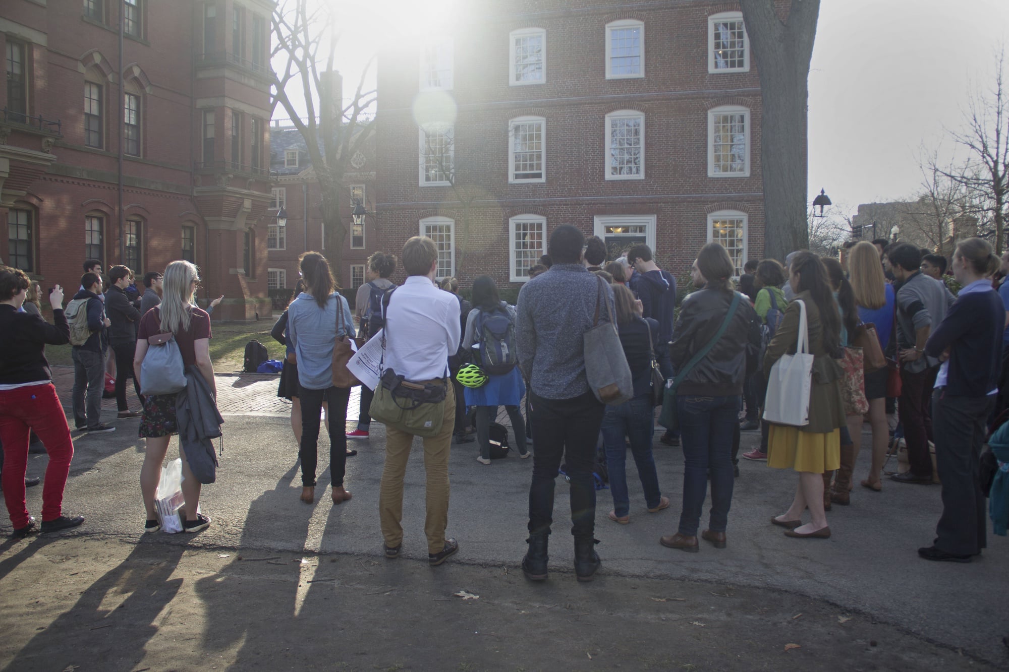 Students from the Graduate School of Arts and Sciences, along with supporters, gather for a protest outside Massachusetts Hall Friday evening. The protest was in demand that more steps be taken to increase diversity at the school.