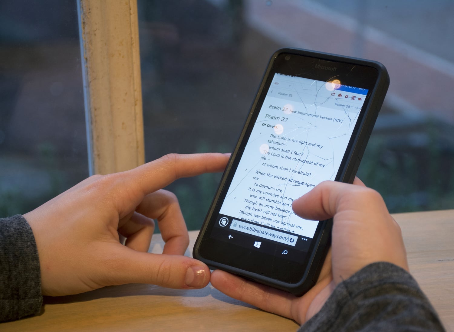Molly L. Richmond ‘18 reads Psalm 27 from her cellphone in Zinnekins, a waffle cafe in Harvard Square. Many students keep favorite bible verses on hand this way.