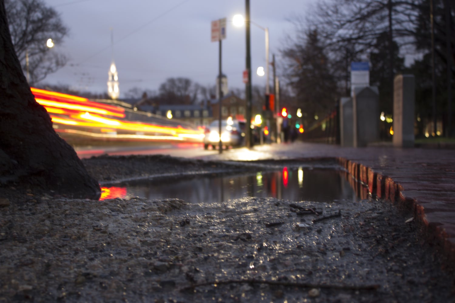 After a long day of rain showers, rush hour commuters in Harvard Square faced slippery roads and more vehicle traffic than usual. Students were equally dismayed by muddy sidewalks and wet clothing.