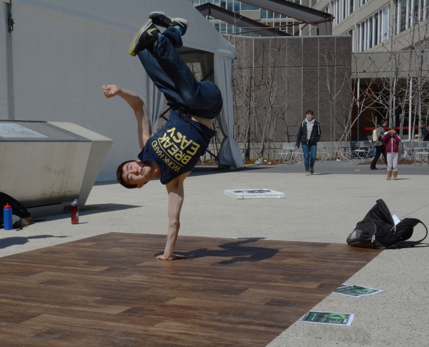 Peter W. Chang ‘18 dances in the Science Center Plaza for potential students to attract them to join Harvard Breakers.