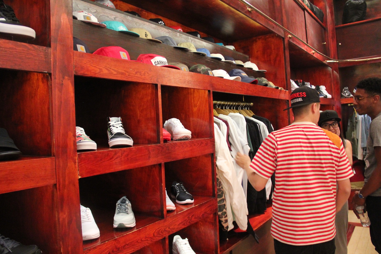 A Bodega salesman talks to customers as he shows them around the store.