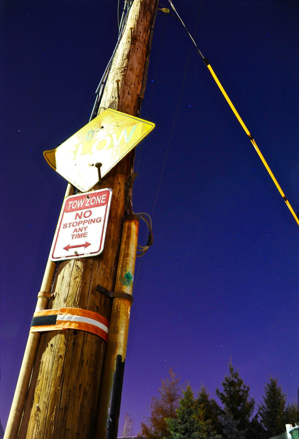 A telephone pole in Allston stands under the night sky.