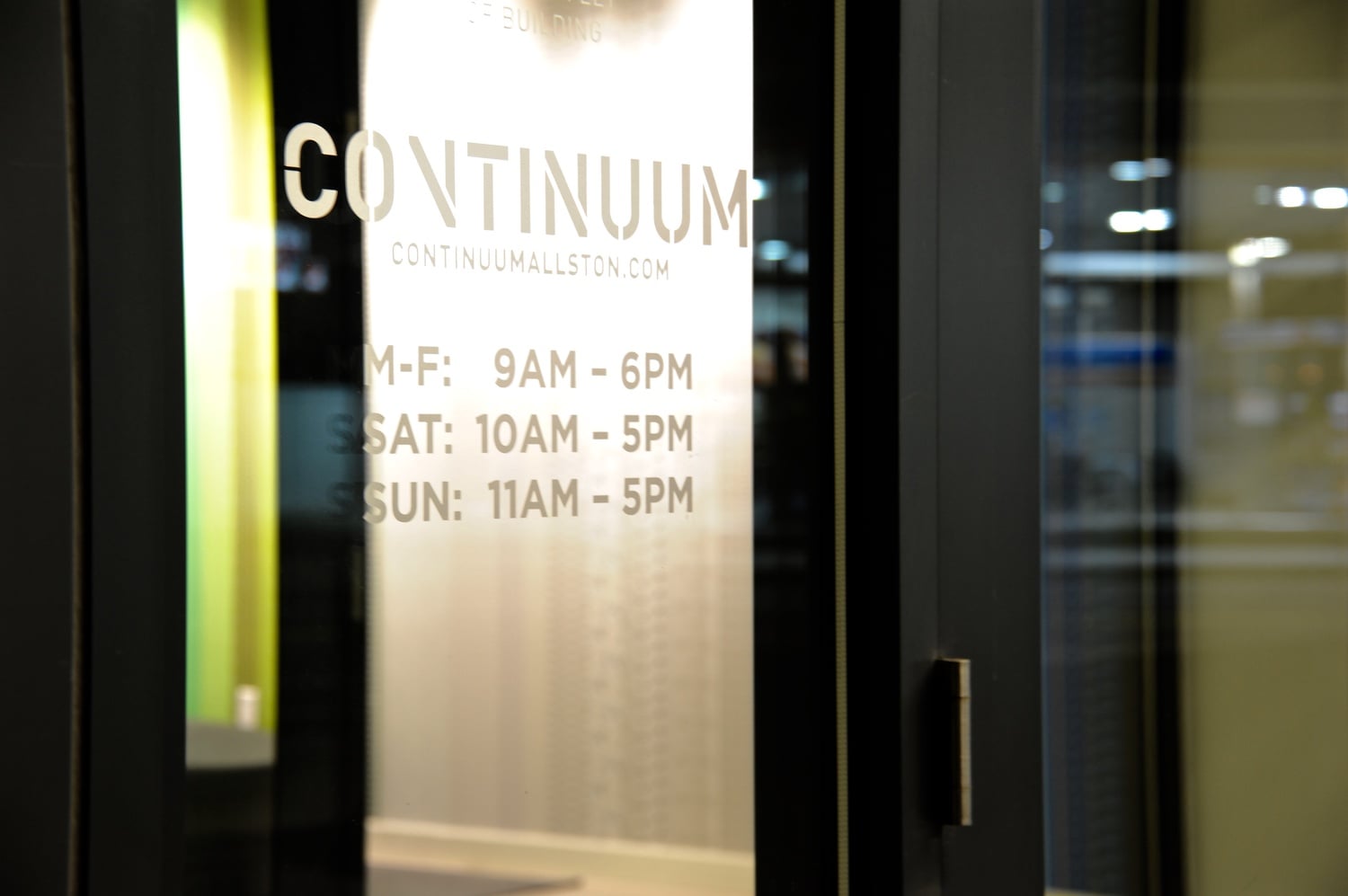 The Continuum's hours are displayed on its lobby windows. Harvard and city officials broke ground on the residential and retail complex--located at the corner of North Harvard Street and Western Avenue--in late 2013, with tenants moving into the completed building this past fall.