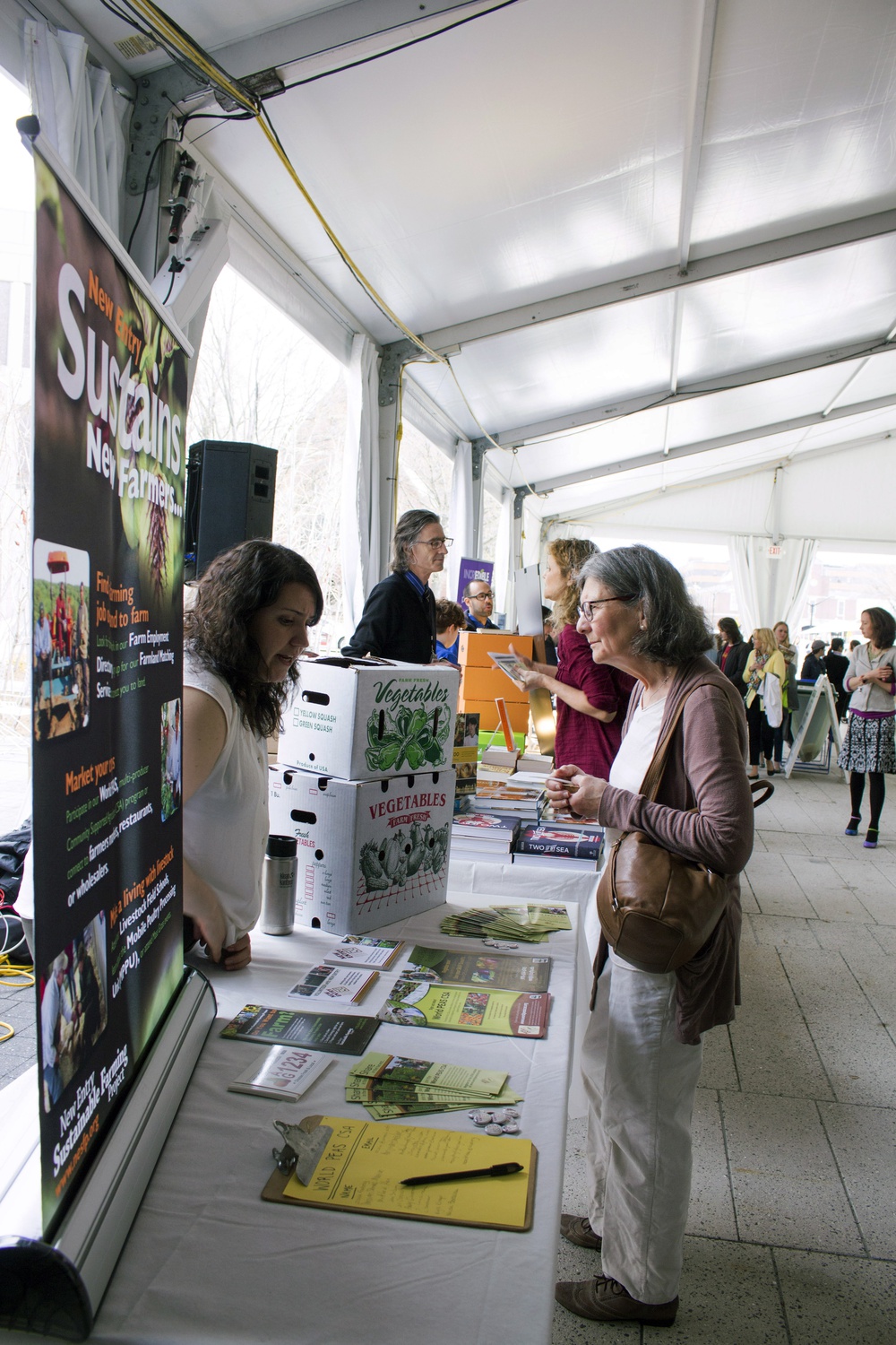 Representatives from local sustainable food companies and organizations spoke with attendees of the “Just Food?” conference on the Science Center Plaza Friday.