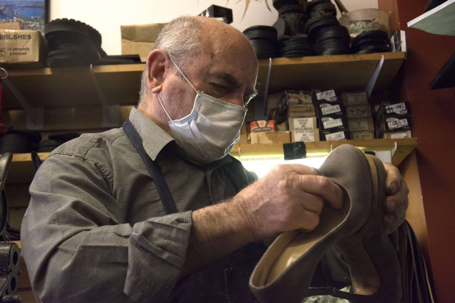 Felix's Shoe Repair owner Christos Soillis inspects a pair of high heeled shoes in his shop on Massachusetts Avenue.