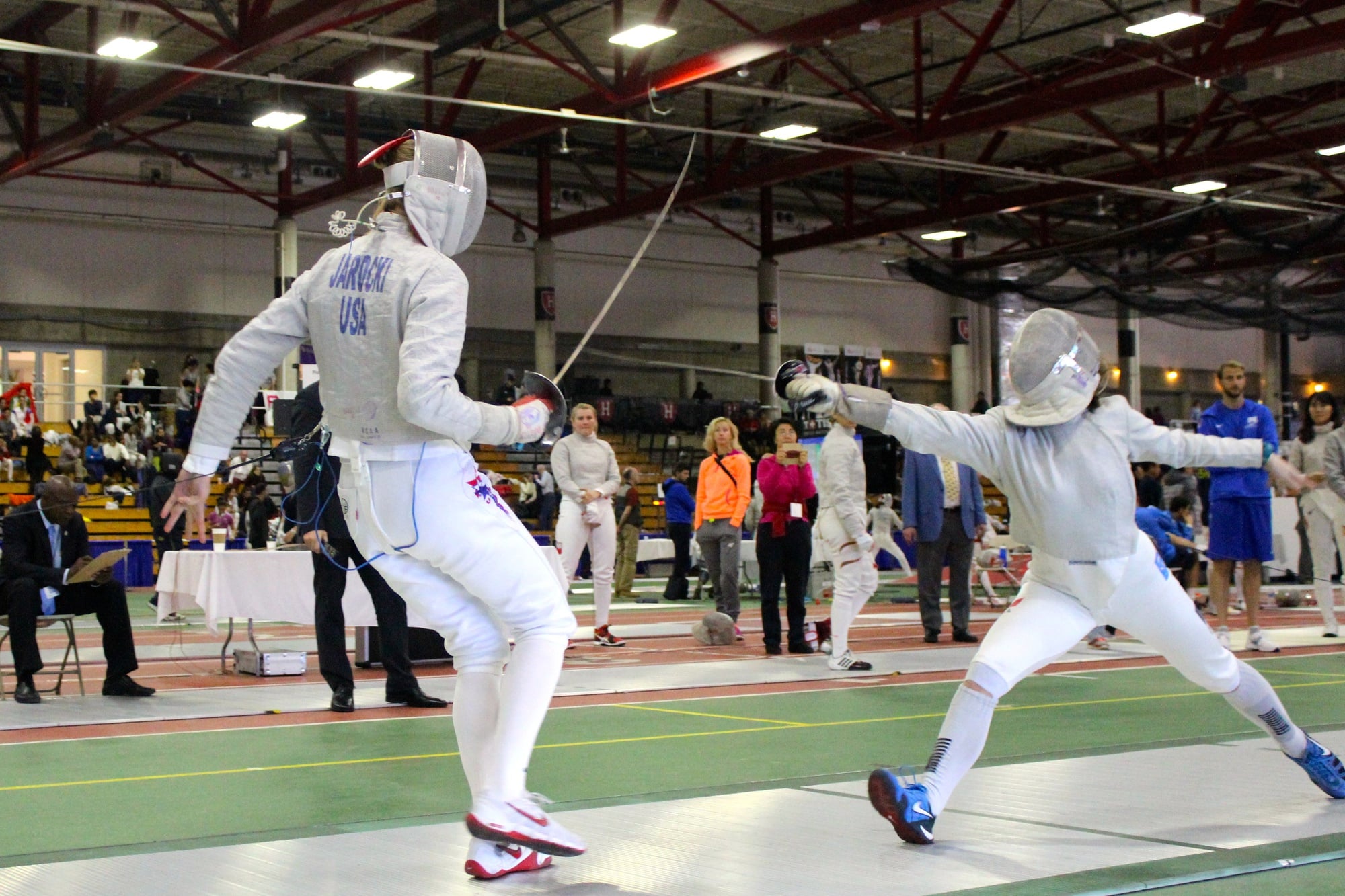 Junior saber fencer Adrienne Jarocki (left) avoids her opponent's attack during the FIE Sabre Grand Prix at the Gordon Indoor Track.