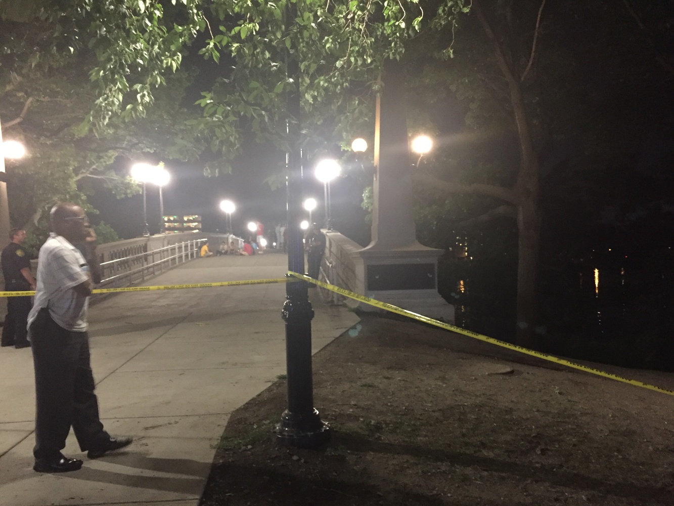 Police stood near Weeks Footbridge. A person was recovered from the Charles Friday night.