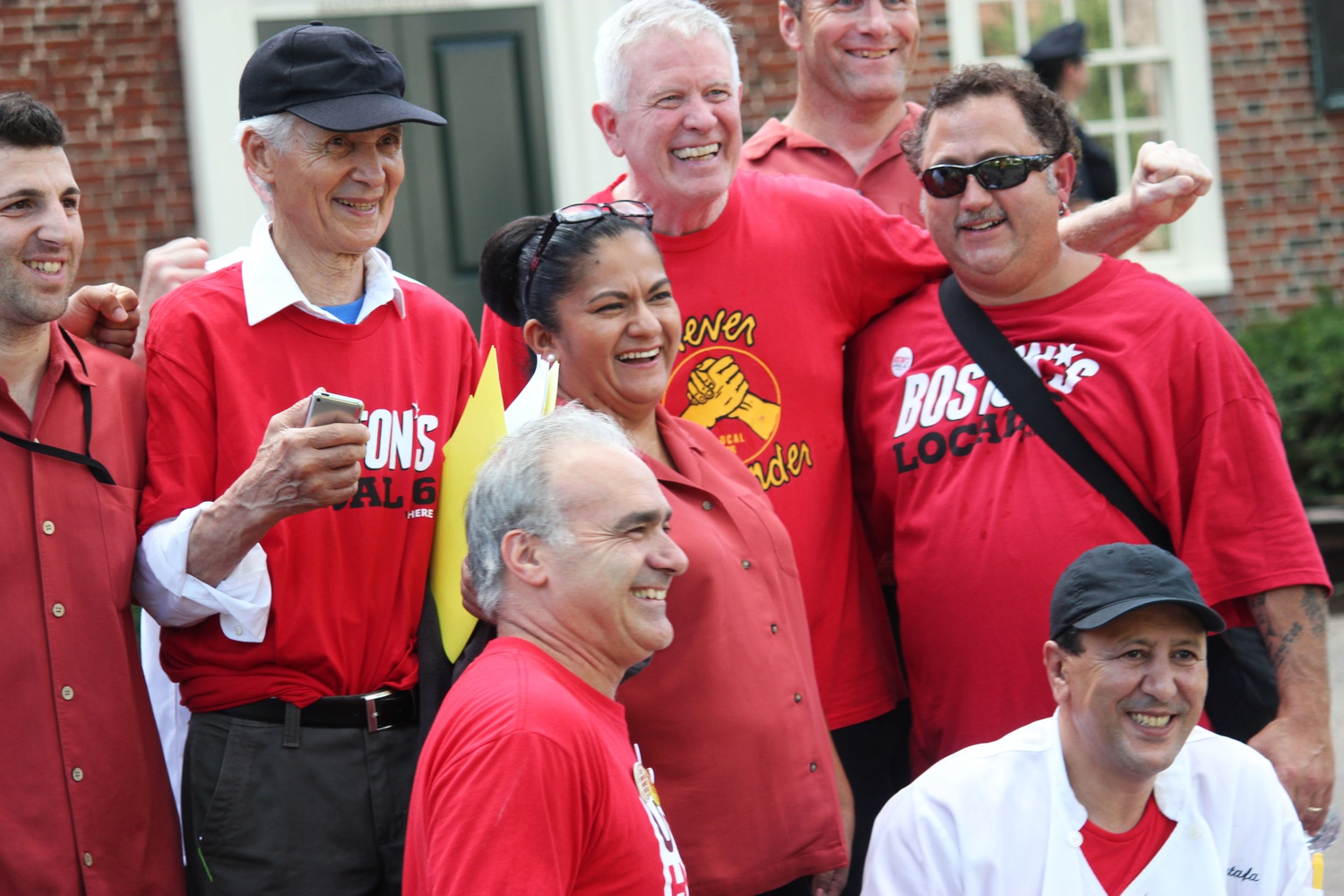 Adams House HUDS staff gather for a photo at the end of Wednesday's rally. 