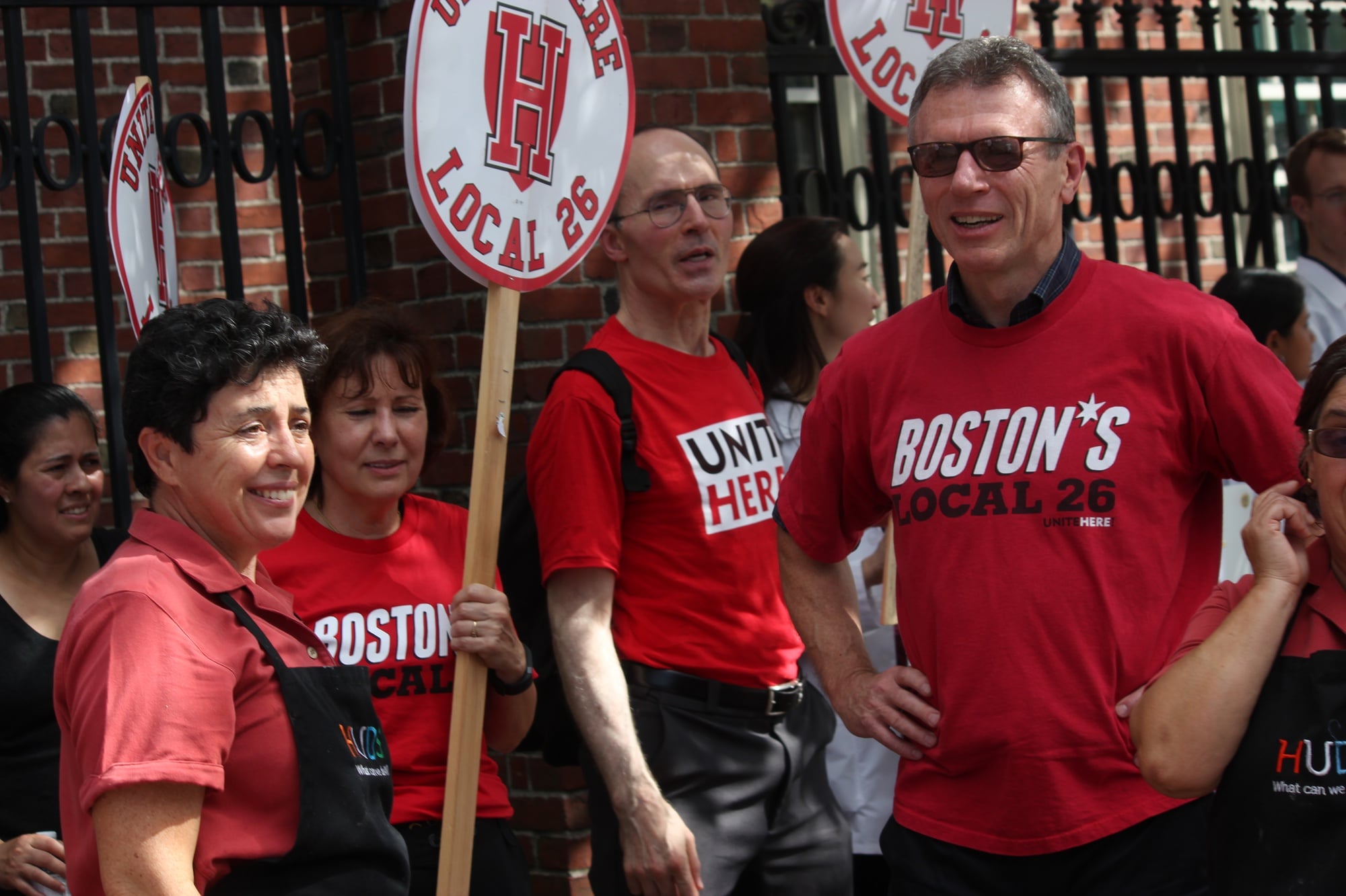 Brian Lang, the president of Local 26, stands alongside HUDS employees during Wednesday's rally on Massachusetts Avenue.