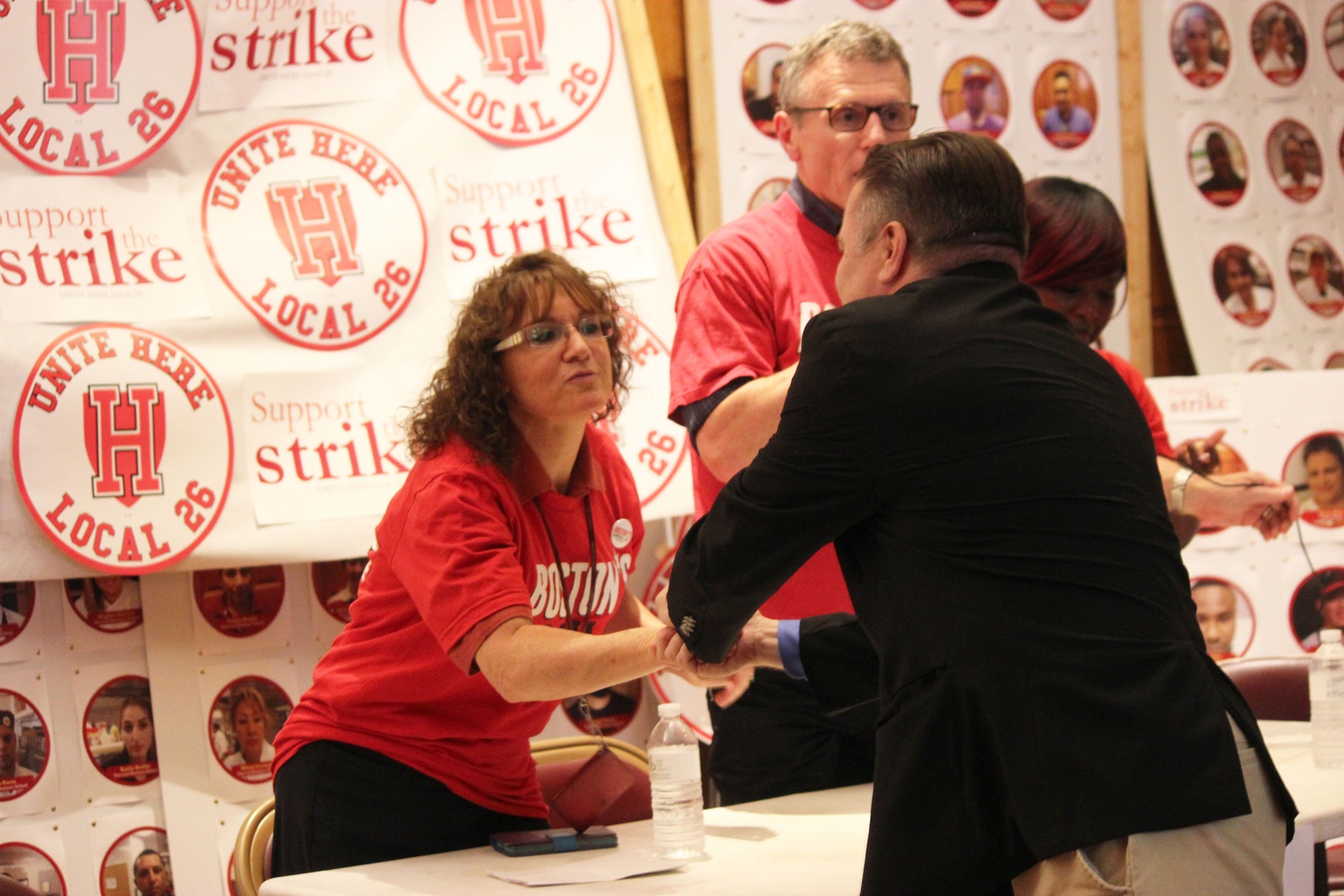 Cambridge City Councilor Marc McGovern shakes hands with HUDS employee Anabela A. Pappas at the HUDS rally on Wednesday. "This is the third time I've had to rally to get Harvard to do the right thing," he said to the audience. "I'm tired of fighting and having to ask one of the most wealthy institutions in the world to do what is right."