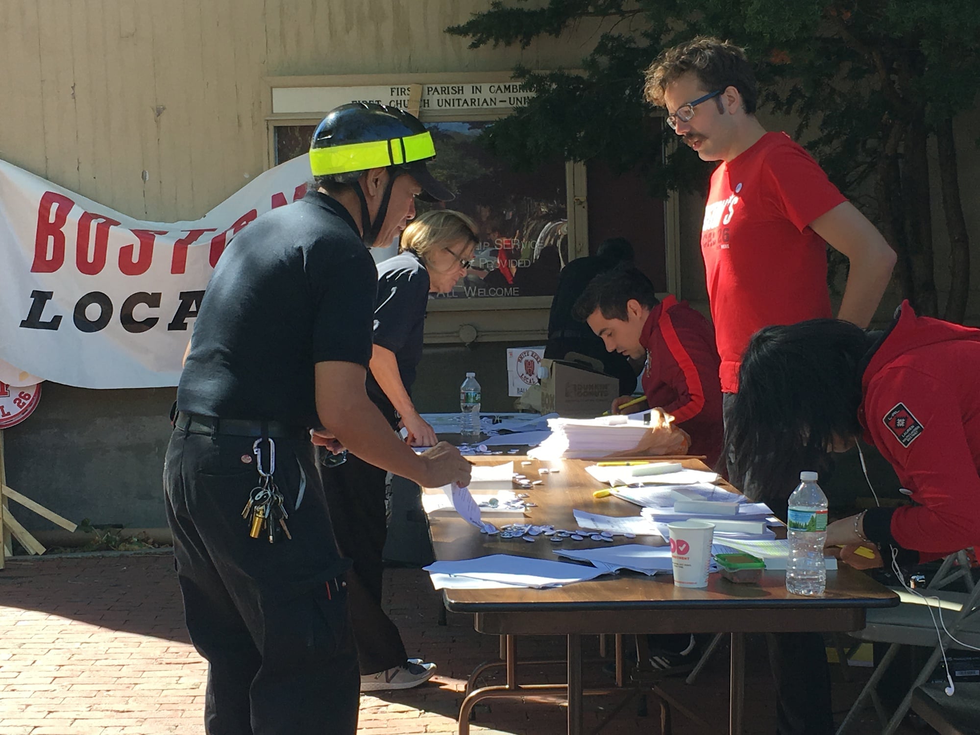 Workers cast their ballots at the HUDS Strike Vote outside First Parish Church in Cambridge on Thursday afternoon.