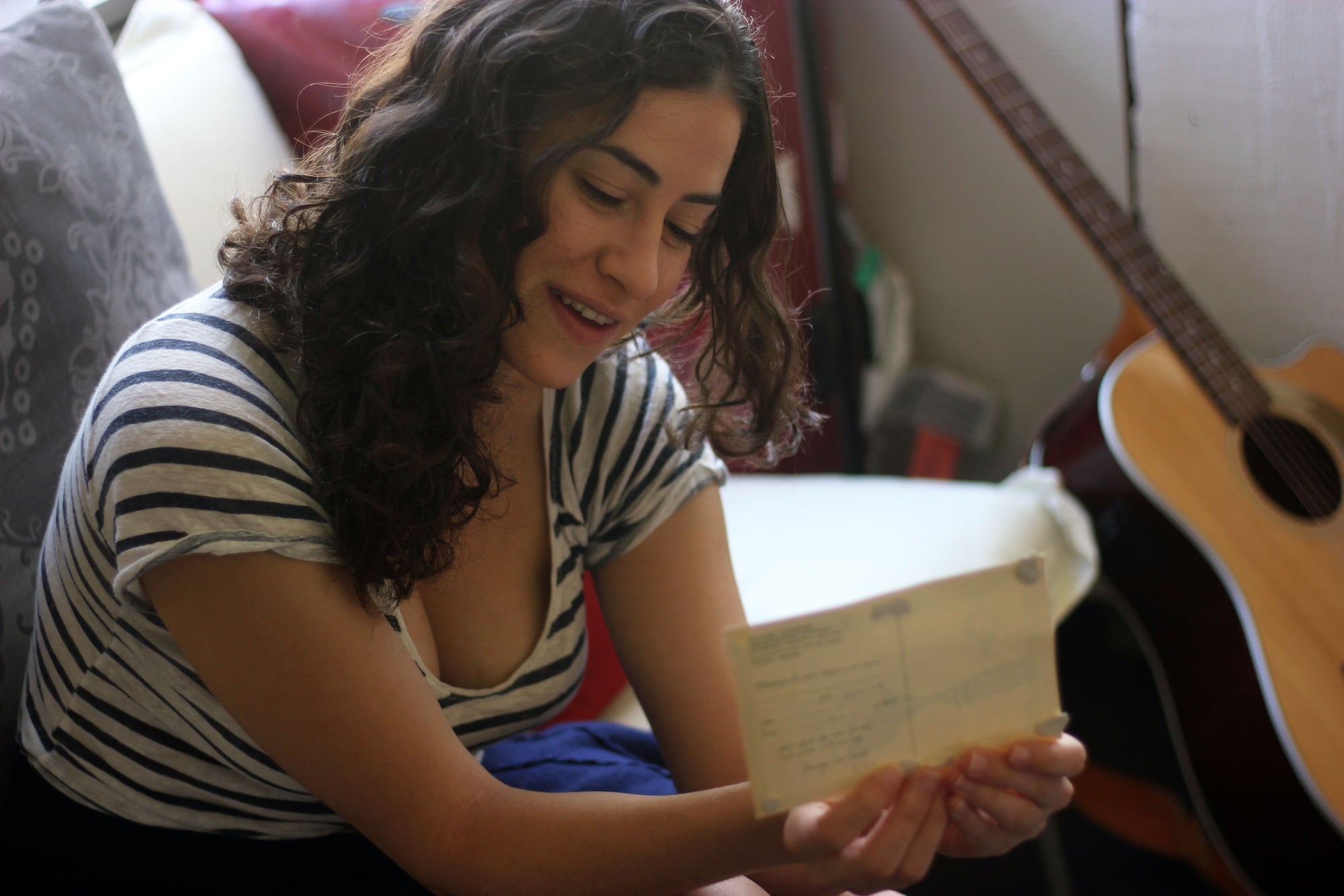 Limor P. Gultchin with a postcard sent to her by friends from the radio program she worked for while serving in the Israeli Defense Forces. 