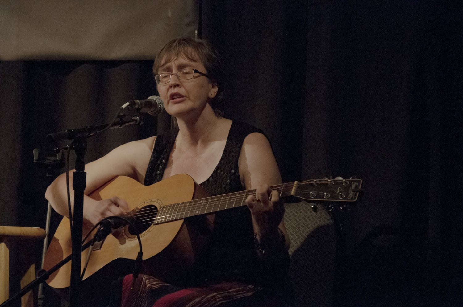 Colleen Goodsell performs an original song at the Club Passim Open Mic Night on Tuesday night. Writing the song allowed Goodsell to work through tough times as “guitar is [her] therapy”.