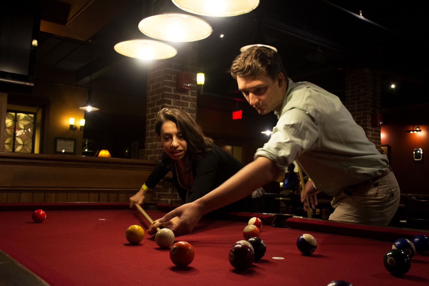 James M. Briggs ’17 guides Edyt J. Dickstein ’17 in a game of pool at the Senior Class Party in the Queen's Head Pub Saturday evening. 