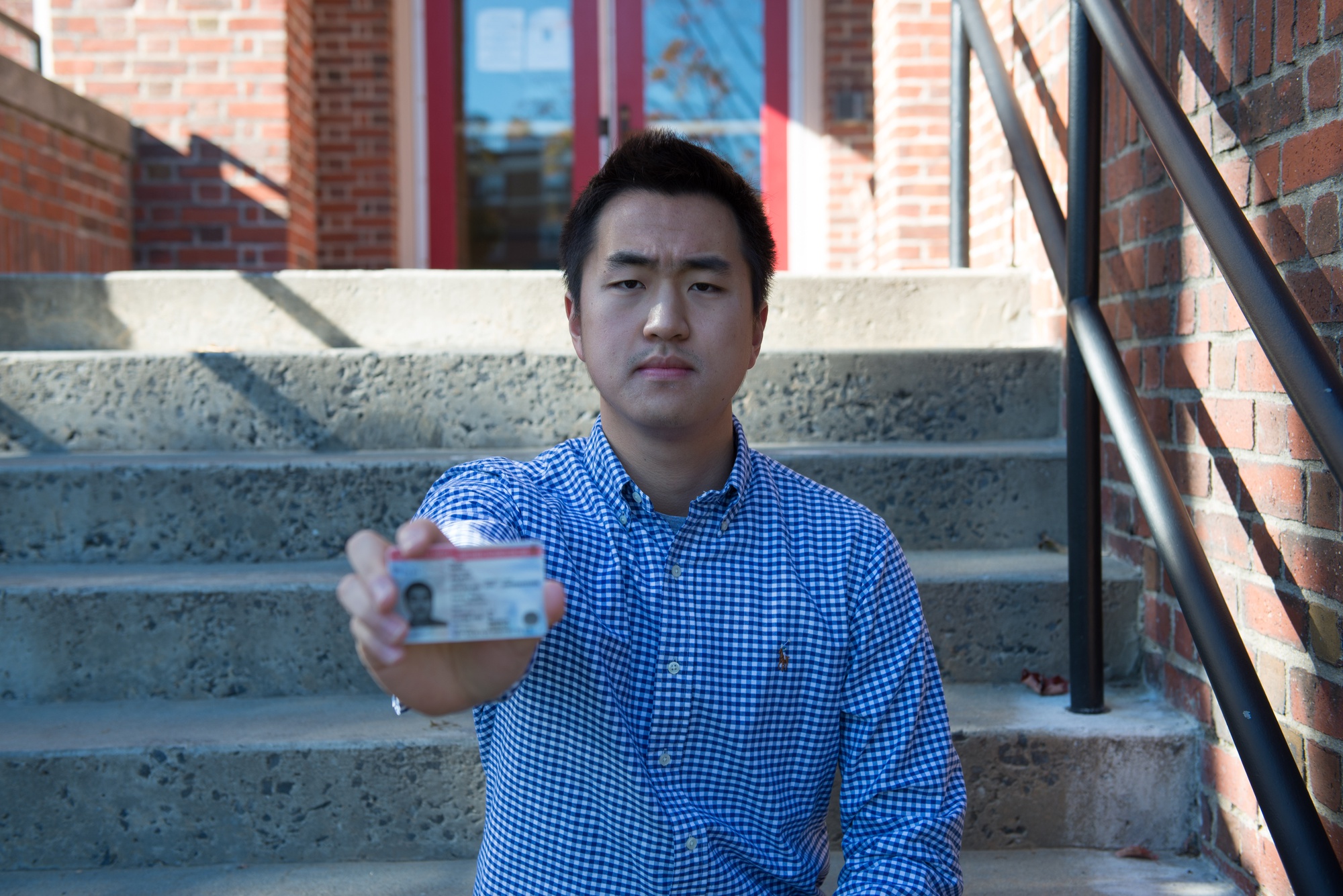 Jin K. Park '18, holding his DACA card, learned English when he moved to the United States when he was 7 years old.