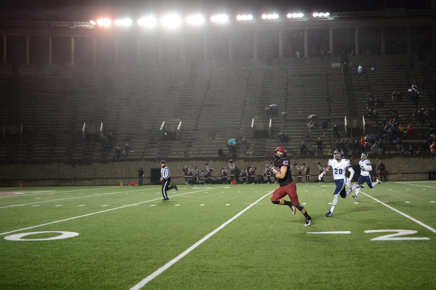 Senior halfback/tight end Anthony Firkser escapes the Georgetown defense for a 75-yard score early in the second quarter. The Crimson leads 24-7 at the end of a rainy first half.