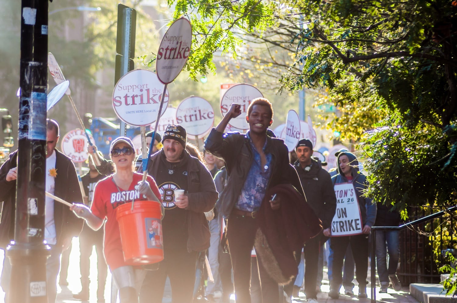 HUDS workers and student supporters chant "Hey Harvard you can't hide; we can see your greedy side," as they march through Harvard Square. The HUDS strike began at 6 a.m. Wednesday morning. 