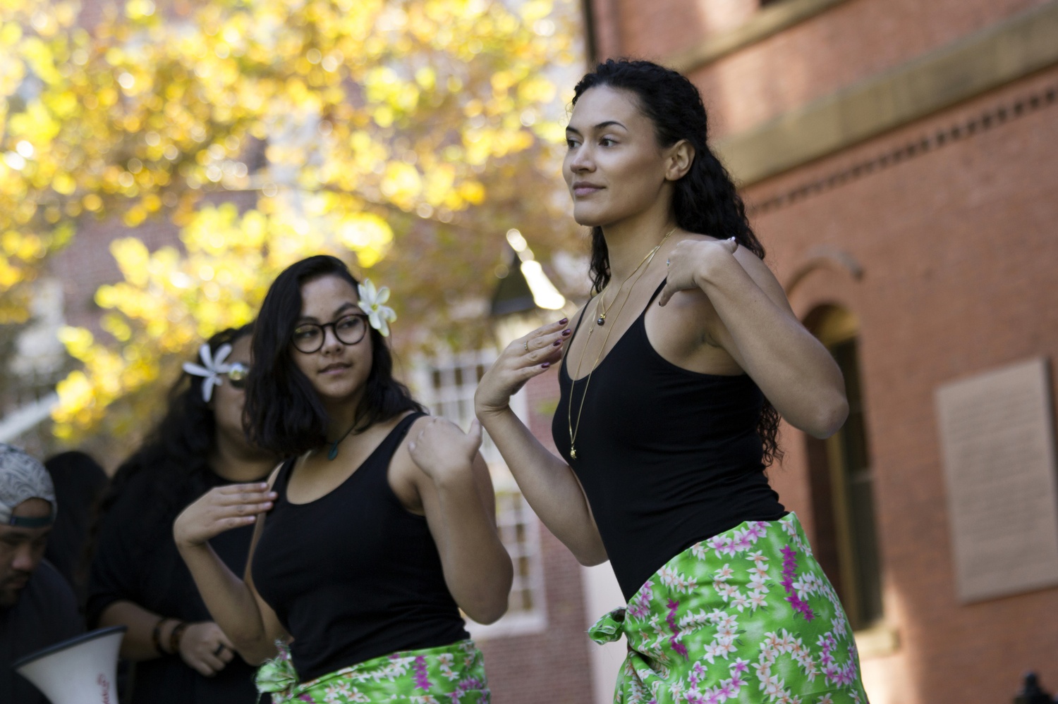 Cantabrigian Pua Higginson, right, and Cambridge Rindge and Latin student Caroline Daley, left, perform a traditional Tahitian dance in Harvard Yard at the celebration of Indigenous Peoples’ Day Monday afternoon. As Harvard University recognizes the holiday as Columbus Day, the culture group Native Americans at Harvard hosted the event to praise native culture and advocate for the university to accept the new title.