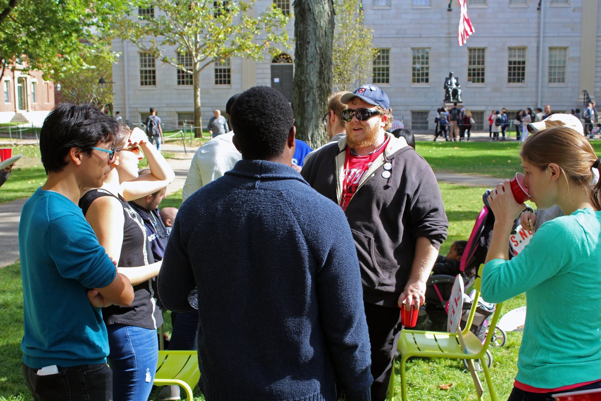 HUDS employee Nick F. Heron, who works in the kitchens of Cabot, Currier & Pforzheimer, speaks with Law School students after sharing lunch with them.