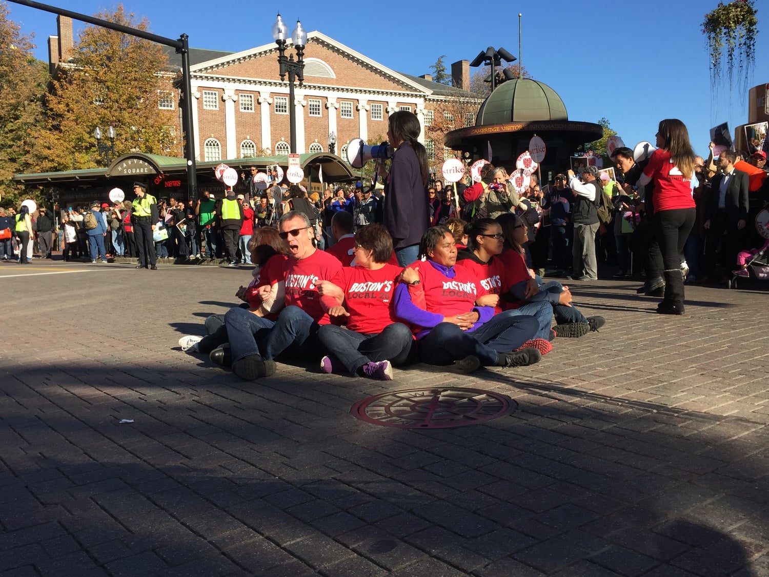 Demonstrators supporting the historic strike of Harvard's dining services workers disrupted traffic in Harvard Square's main intersection Friday.