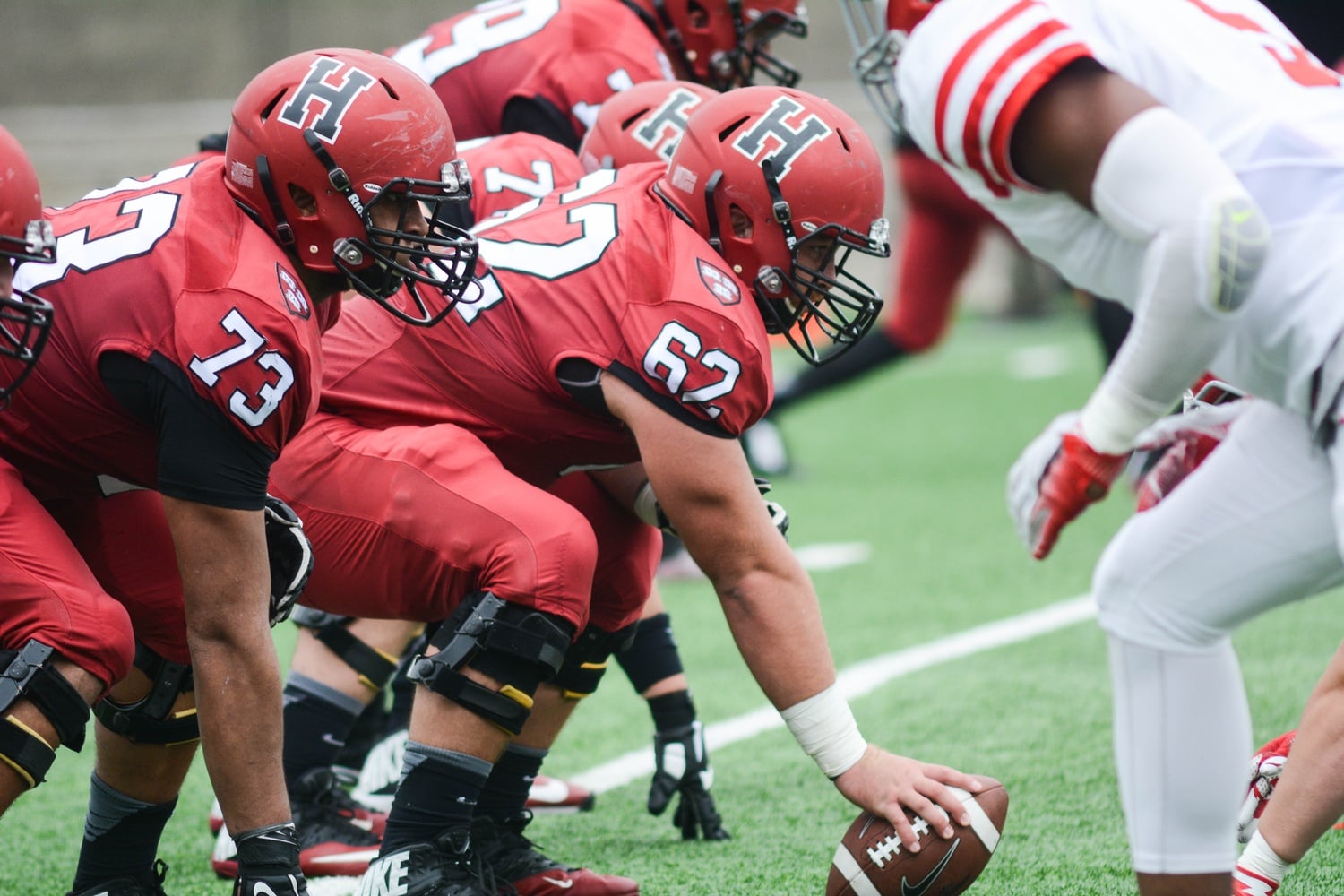 Offensive linesmen senior Kyle Adams and junior Larry Allen prepare to snap the ball during Harvard’s game against Cornell on October 8. The team will need to get back its offensive rhythm to match Princeton’s high-octane offense, as well as stay diligent on defense, in order to leave Princeton, N.J. with a win.