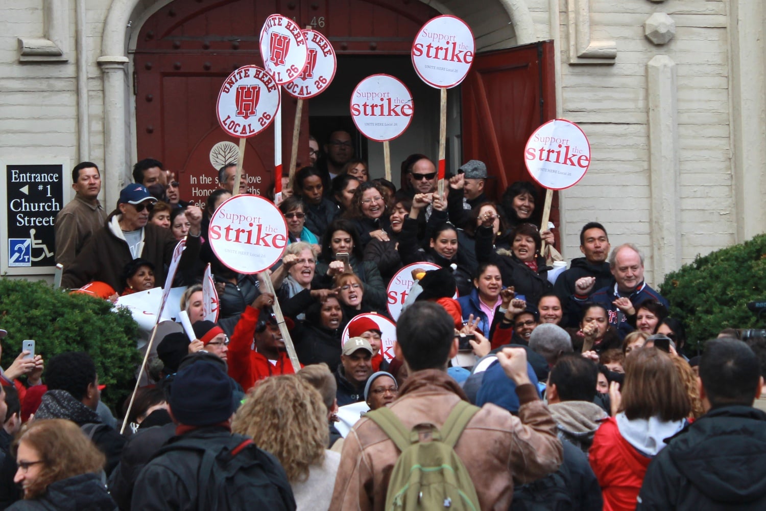 HUDS employees and union members celebrate at the contract announcement rally on the steps of  First Parish Church Wednesday afternoon.