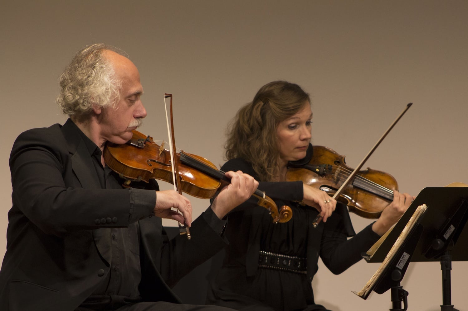 Mikhail Bondarev and Ekaterina Belisova, two members of St. Petersburg’s Rimsky-Korsakov String Quartet, play during a group performance at the Harvard Ed Portal on Wednesday night.