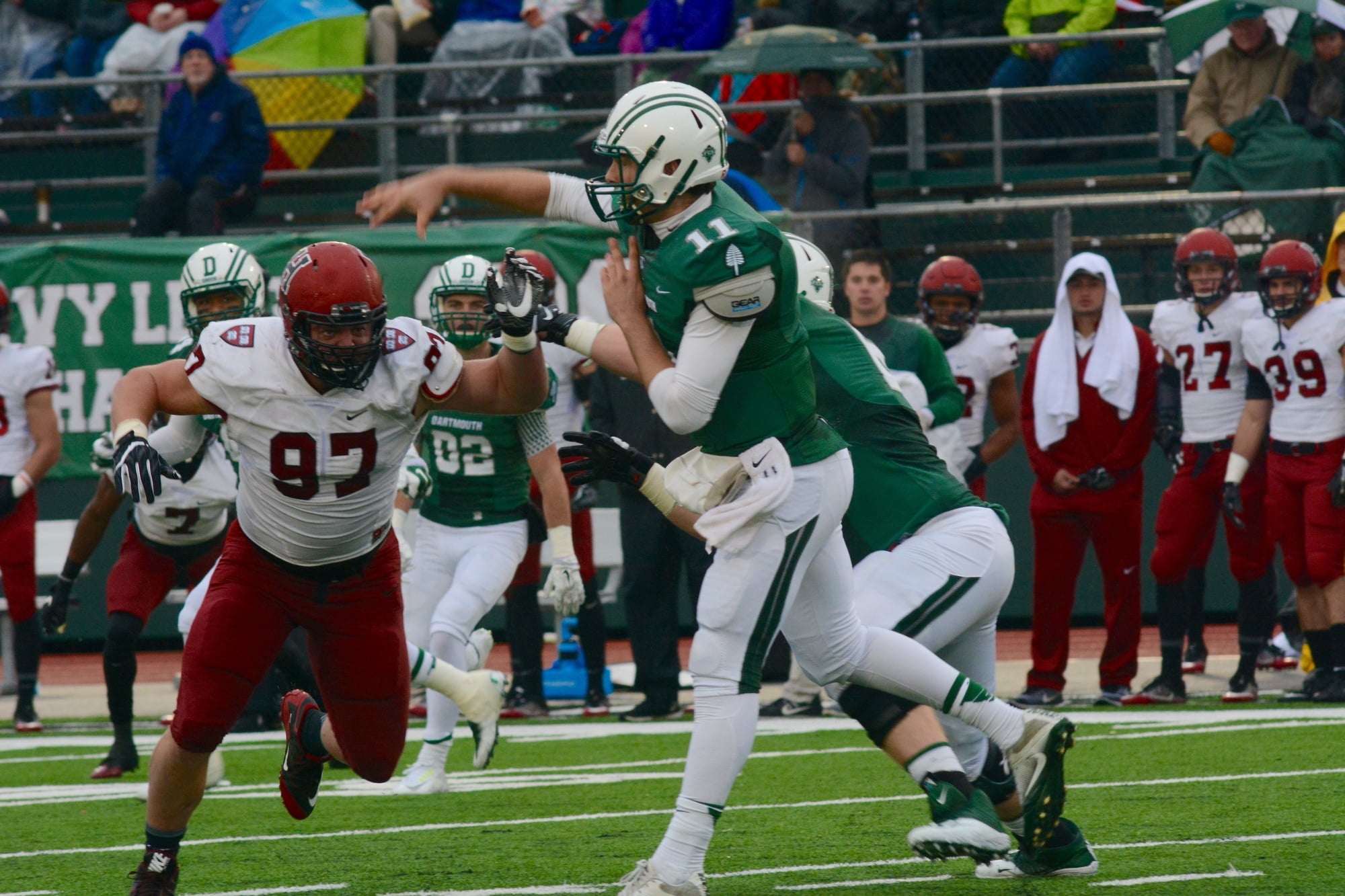 Senior defensive end James Duberg closes on Dartmouth quarterback Jack Heneghan. Although Harvard took a 14-0 lead in the first quarter, the Big Green came back late in the game, forcing the Crimson defense to step up.
