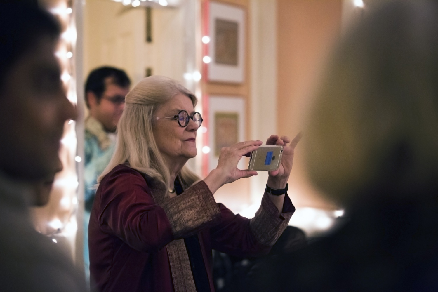 Diana L. Eck, Lowell House Faculty Dean, photographs the Hindu festival of lights celebration for which she opened the Lowell House Faculty Deans' residence. During the ceremony, Eck expressed gratitude and honor to Harvard Dharma for holding the event in her residence.