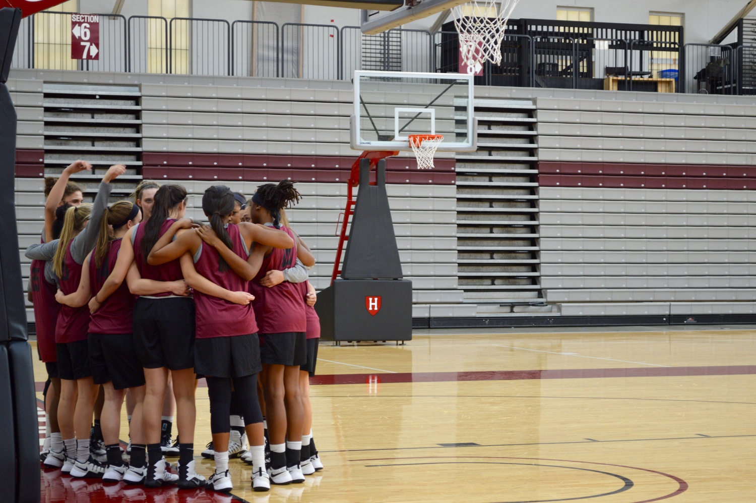 The Harvard women's basketball team huddles up after a recent practice. After losing three key seniors, the Crimson has reloaded with a Stanford transfer and pair of impressive freshmen.