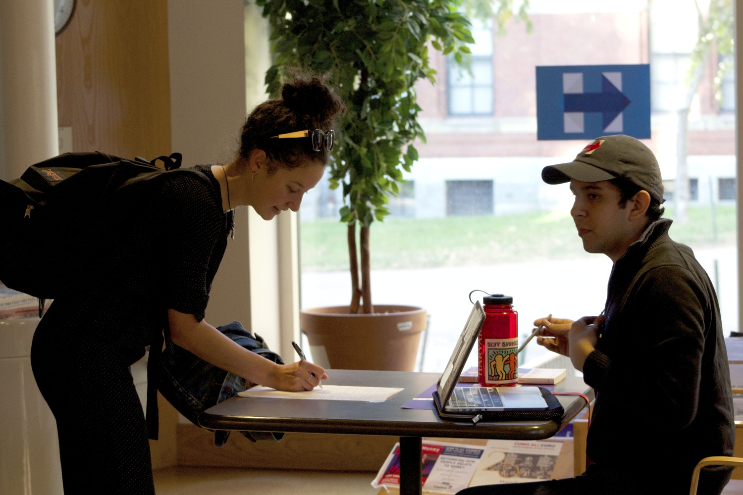 Reuben E. Reyes Jr. ‘19, an active Crimson editor, signs students into a get out the vote event for the Harvard Democrats in Ticknor Lounge on Tuesday.
