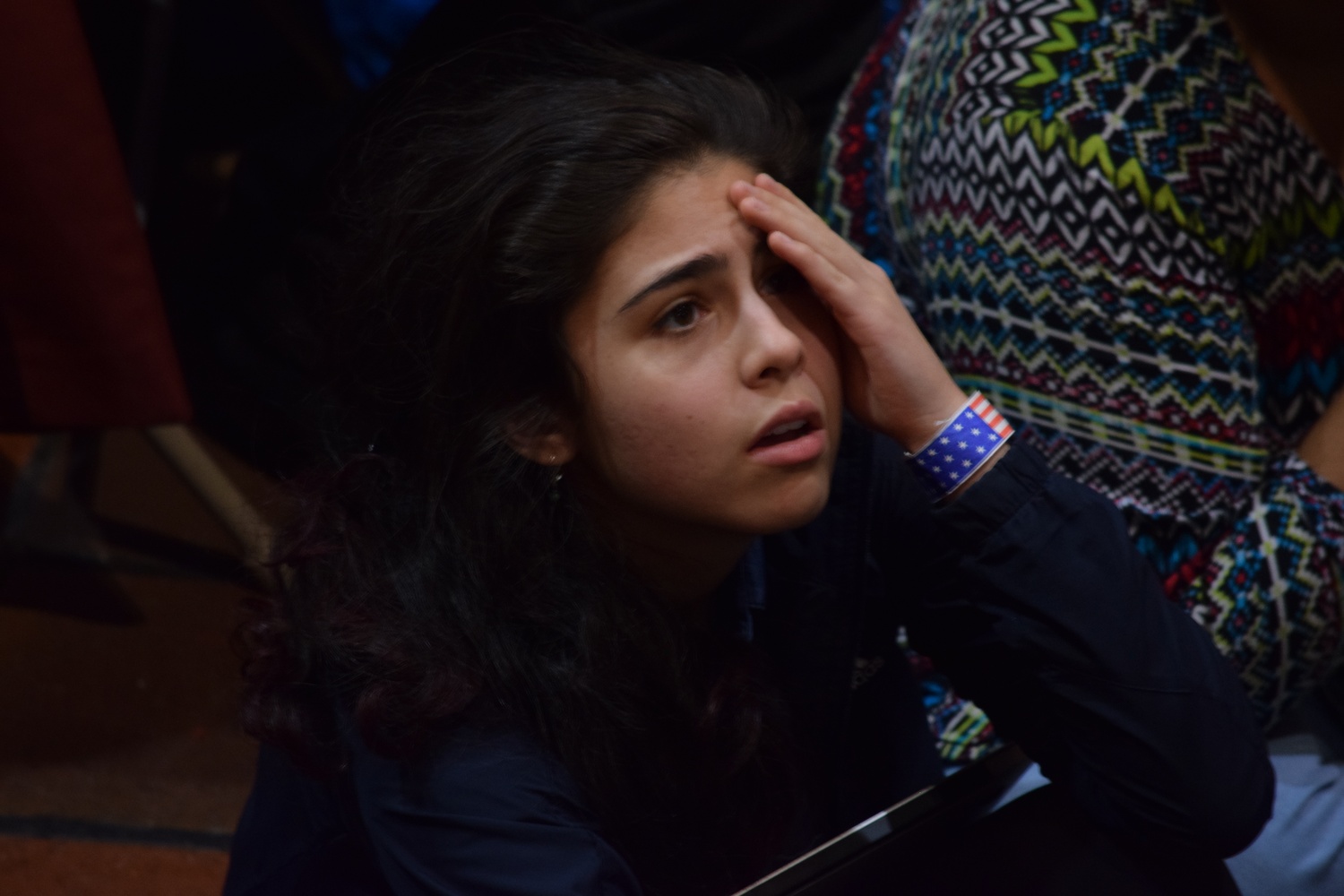 Emily Oliveira ‘18 looks on in grief while watching the election results come in on Tuesday night at the IOP watch party.