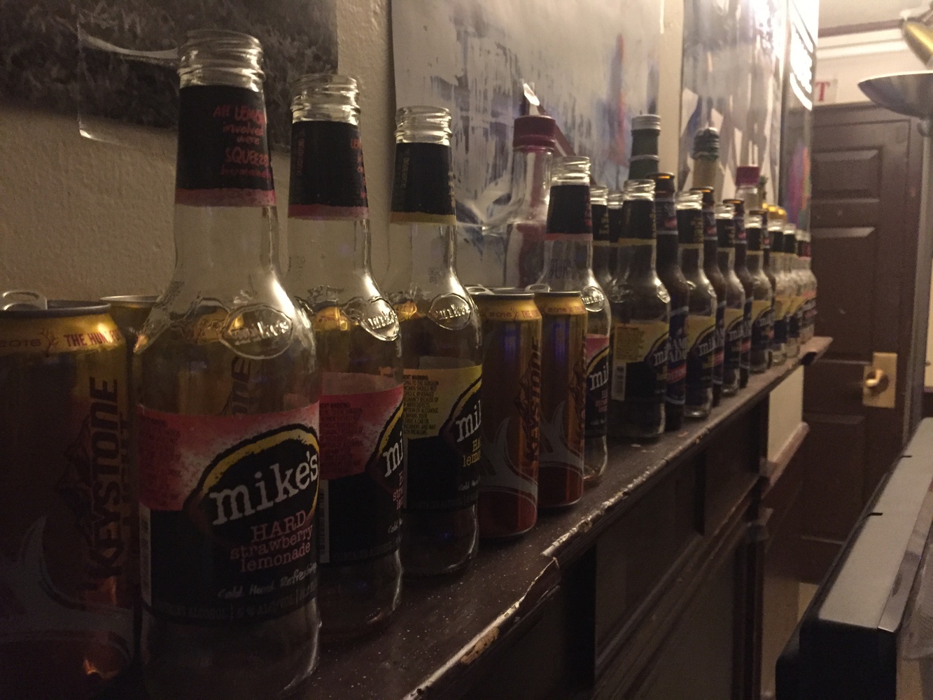 Your obligatory photo of empty bottles lining one of Harvard's faux fireplaces. #soclassy 
