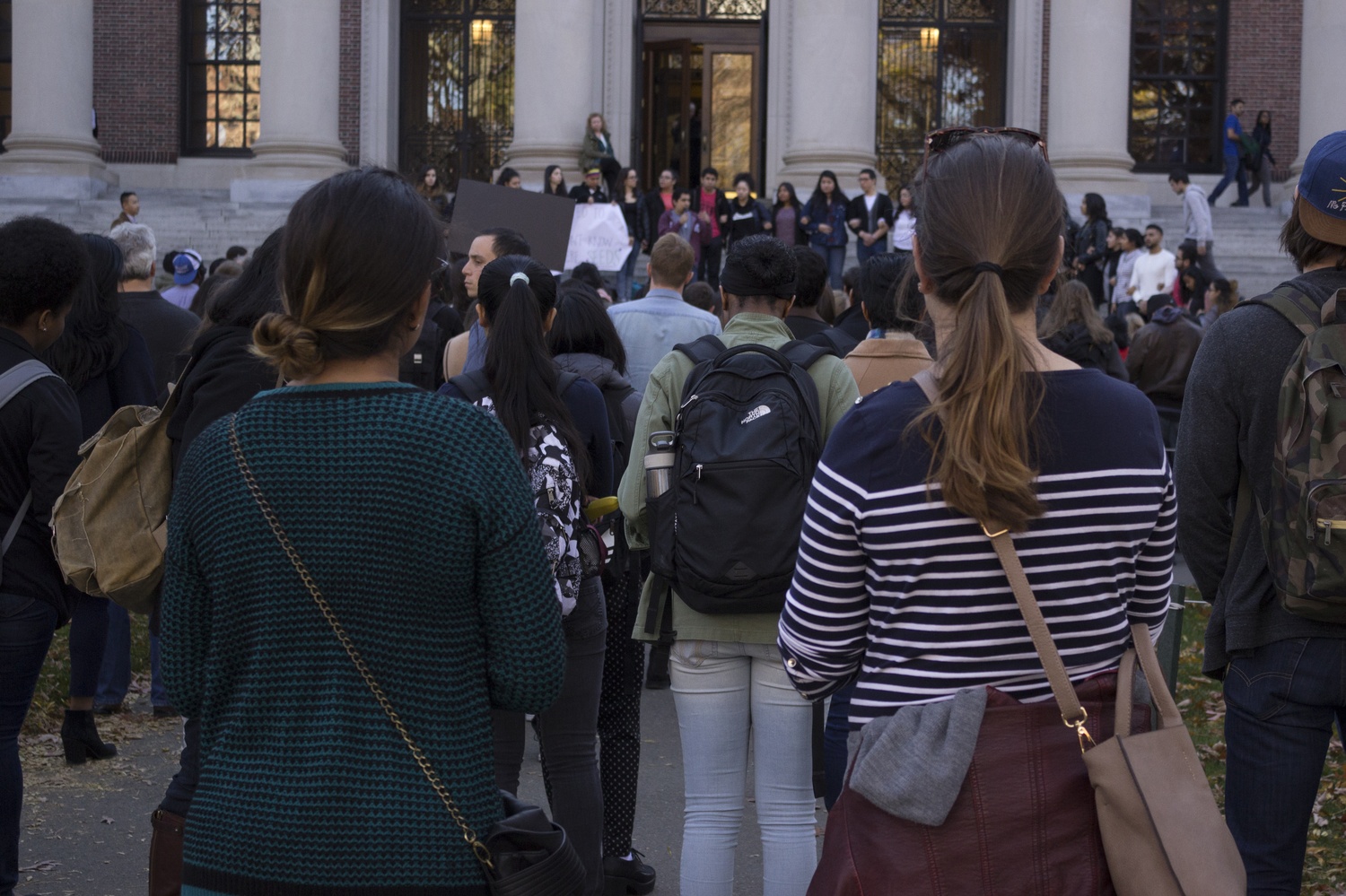 As hundreds collected outside of Widener Library, undocumented Harvard students took turns encouraging the university to protect its diverse community following the election of Donald Trump.