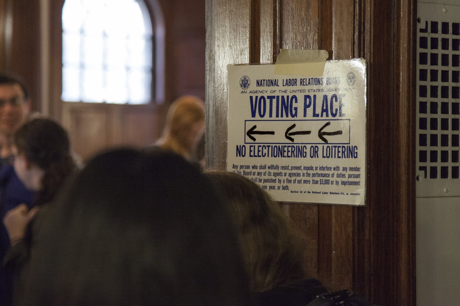 A posted sign directs voters to the polling place for the Harvard Graduate Students Union-UAW unionization vote in Phillips Brooks House last month.